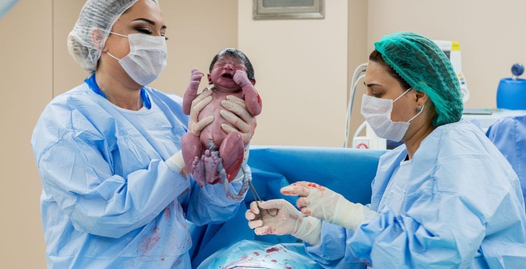 Surgeons performing a c-section